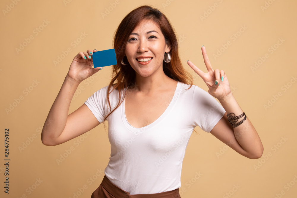 Young Asian woman show Victory with a blank card. Young Asian woman show Victory with a blank card.