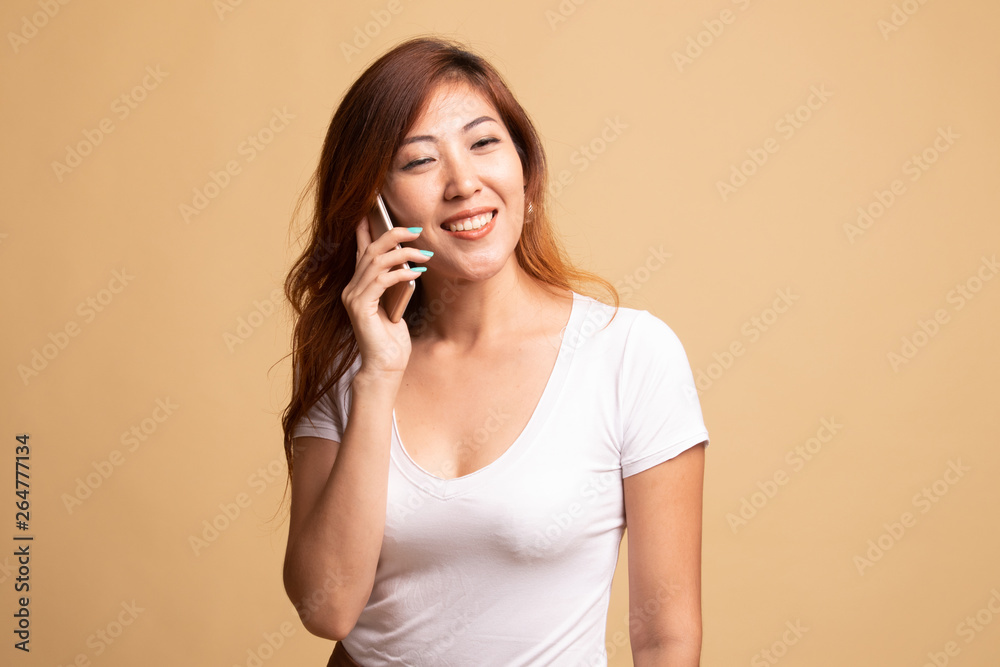 Young Asian woman talking with mobile phone. Young Asian woman talking with mobile phone.