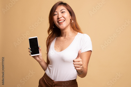 Young Asian woman show thumb up with mobile phone.