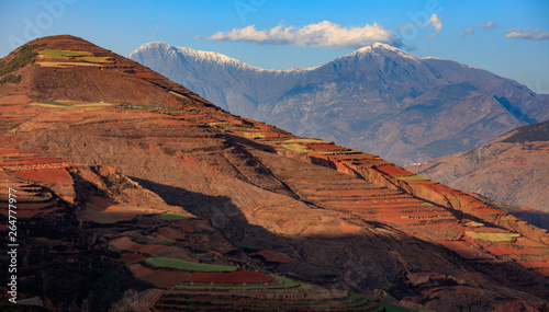 Dongchuan Colored Red Earth Terraces - Red Soil  Green Grass  Layered Terraces in Yunnan Province  China. Chinese Countryside  Agriculture  Exotic Unique Landscape. Farmland  Agriculture