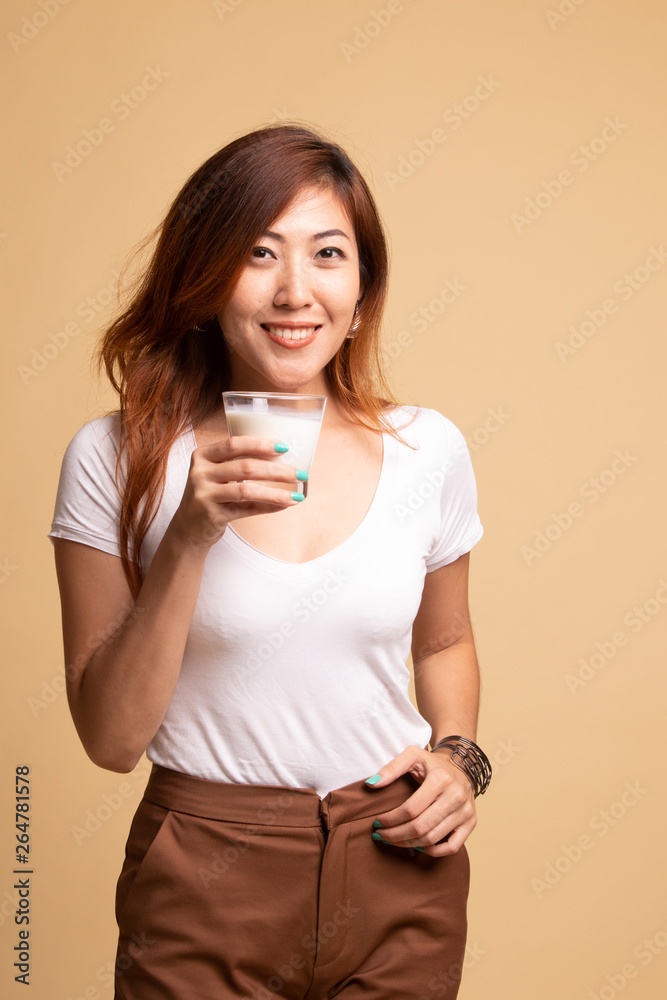 Healthy Asian woman drinking a glass of milk. Healthy Asian woman drinking a glass of milk.