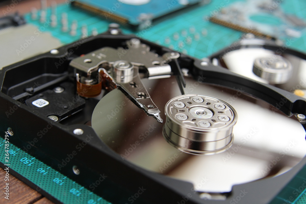 the hard drive is disassembled on the table with tools the hard drive is disassembled on the table with tools