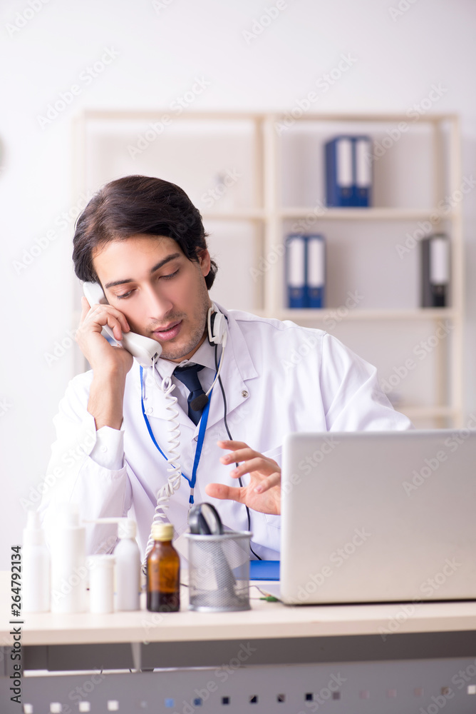 Young male doctor in telemedicine concept Young male doctor in telemedicine concept