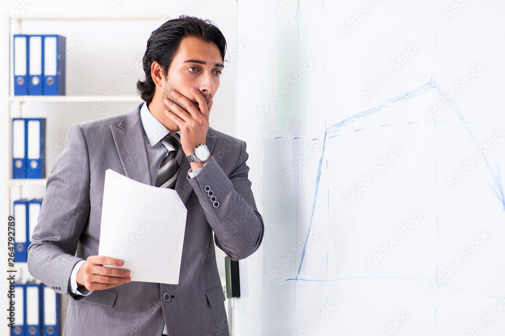 Young handsome businessman in front of whiteboard Young handsome businessman in front of whiteboard