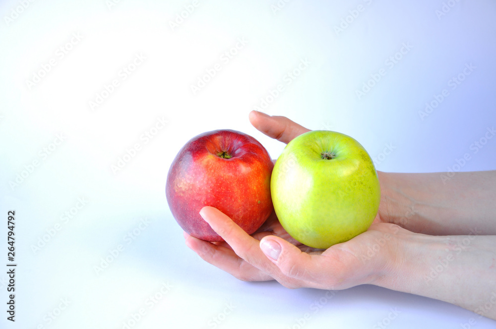 man holds in both hands two apples red and green man holds in both hands two apples red and green