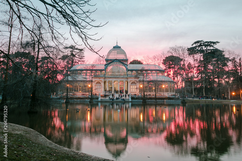 Retiro Park ( Crystal Palace at sunset) is located in the center of Madrid, Spain.
