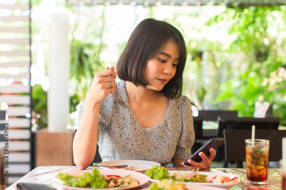 asian  young woman enjoy eating with thai food