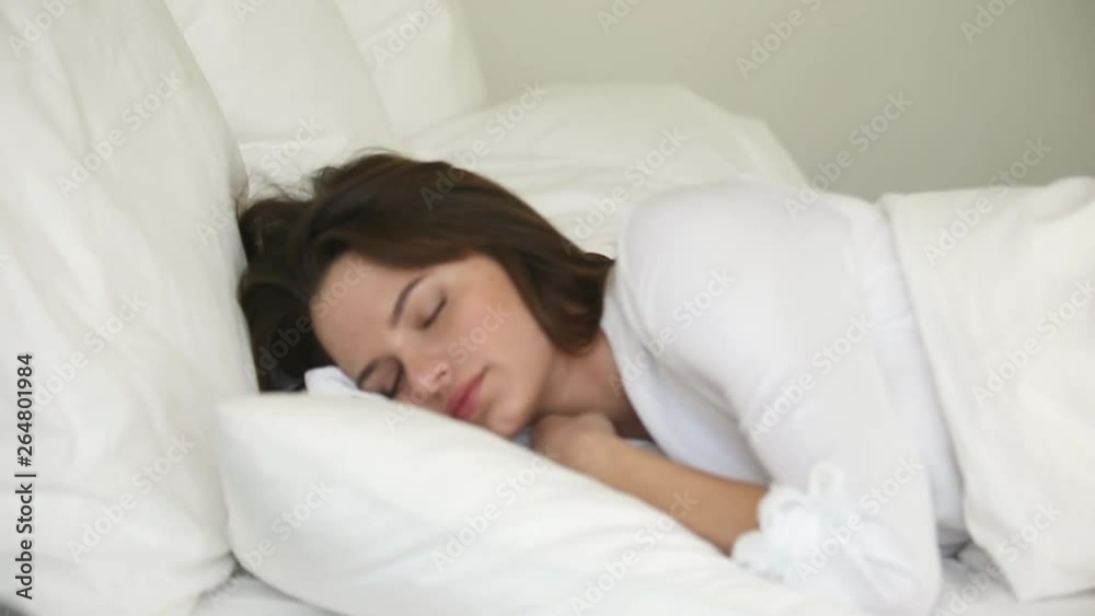 Young woman tossing and turning in bed suffer from insomnia Young woman tossing and turning in bed suffer from insomnia