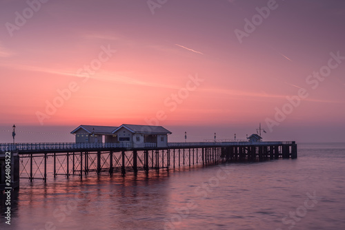 Penarth Pier  on the south Wales coast  near Cardiff  at sunrise. The sky is red and orange  and the sea is smooth