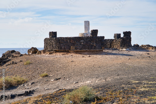 Lanzarote, Canary Islands, Spain. Rocky beach, volcanic rock. Fortress on the volcano