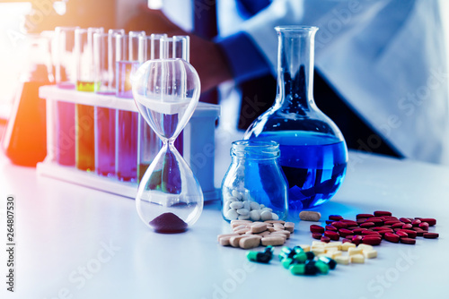 Colorful medicine pills and tablets in pharmaceutical lab. Concept of medical technology research and development for future cure of illness. photo