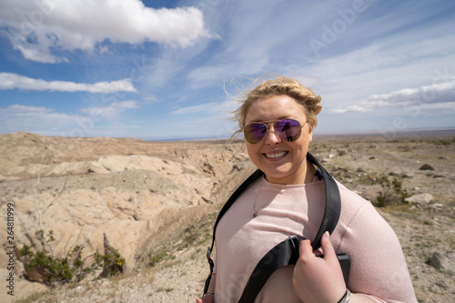 Woman tourist (20s) poses at the Borrego Badlands overlook in Anza Borrego Desert State Park in CA photo