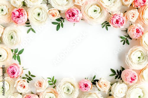 Floral pattern frame made of pink ranunculus and roses flower buds on white background. Flat lay, top view floral background.