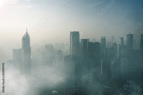 Foggy skyscrapers in Jakarta downtown at morning