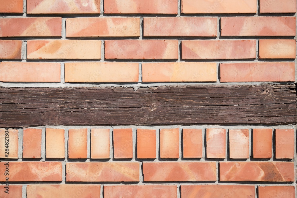 Fototapeta premium Light orange brick background with rustic brown wooden board