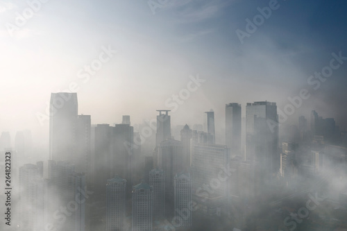 Office building covered by fog in Jakarta city