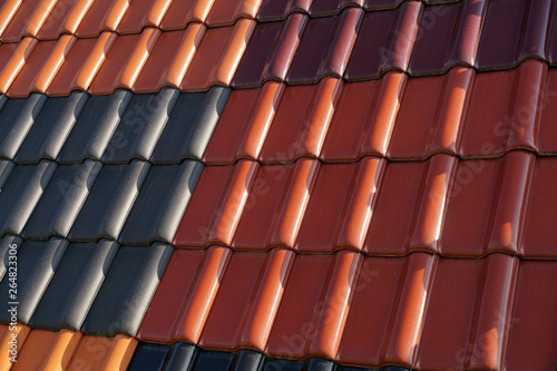 Roof covered with tiles in different colors. Roofing.