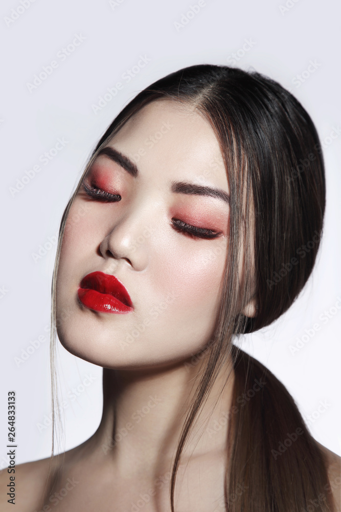 Portrait of young beautiful asian girl with long hair and red lipstick
