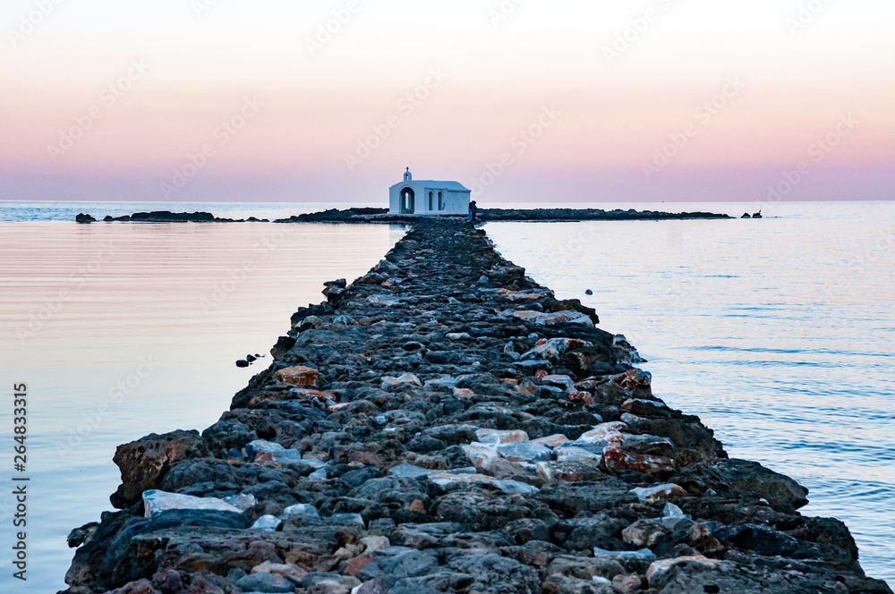 rocky pier leads to a small church rocky pier leads to a small church