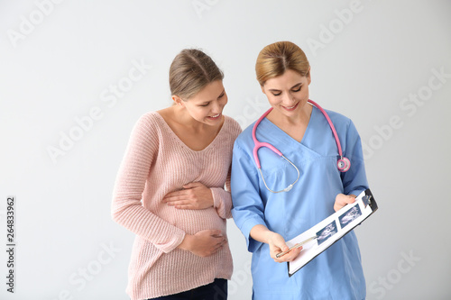 Gynecologist with young pre...