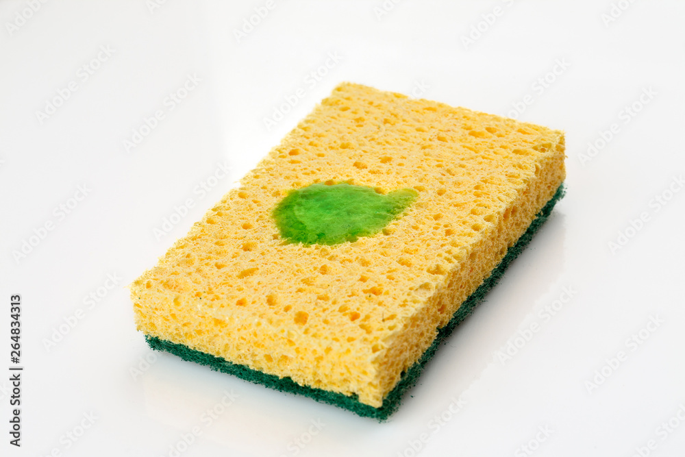 Yellow sponge with some cleaning green liquid on it Yellow sponge with some cleaning green liquid on it