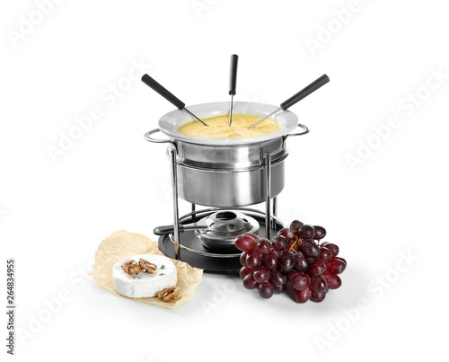 Fondue pot with melted cheese and products on white background