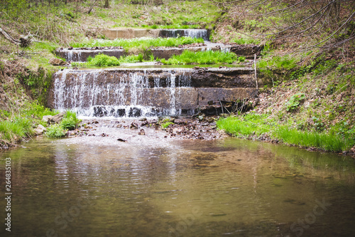 Refreshing summer mountain waterfall background