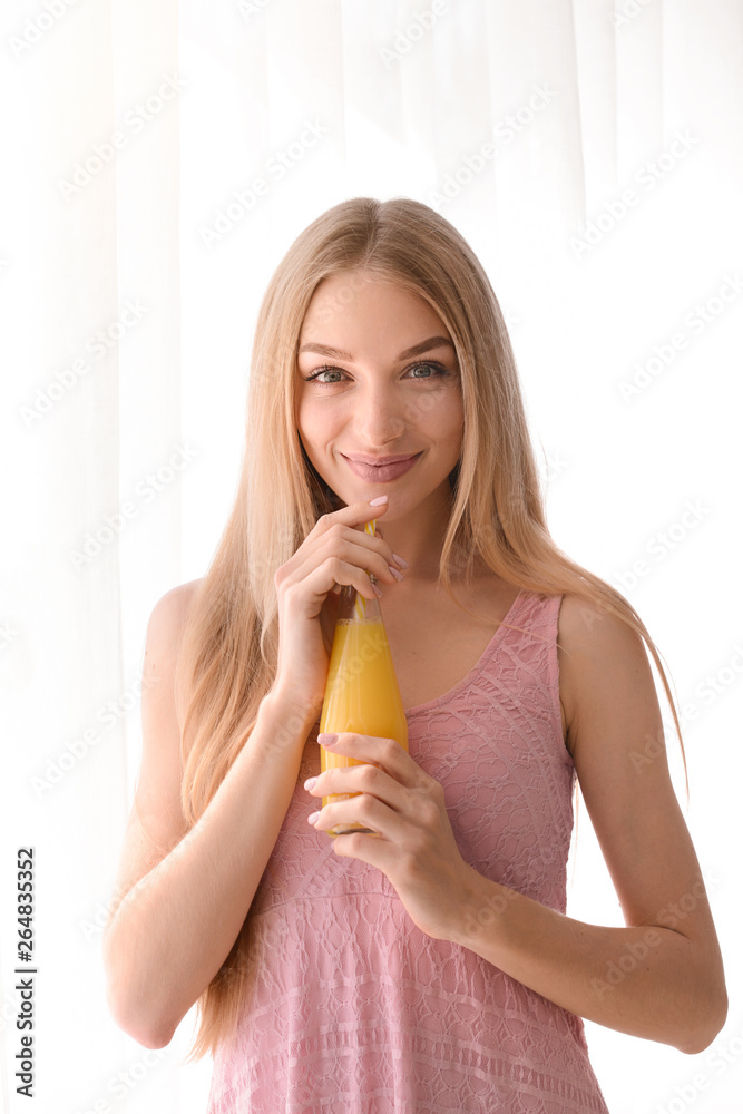 Beautiful young woman with fresh juice near window Beautiful young woman with fresh juice near window