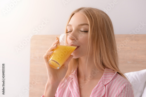 Beautiful young woman drink...