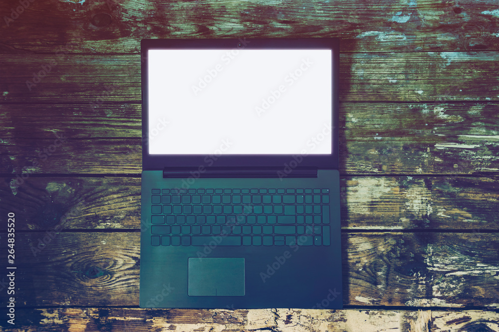 custom made wallpaper toronto digitallaptop on old wooden background. On the laptop screen white background