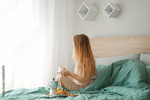 Young woman having breakfas...