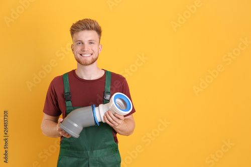 Handsome young plumber on c...