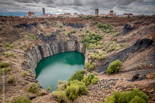 Wide view of The Big Hole in Kimberley, a result of the mining industry, with the town skyline on the edge