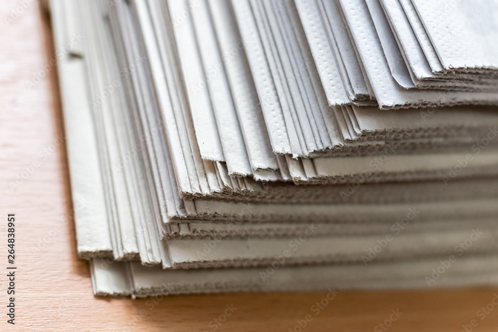 A stack of newspapers close-up. Lots of jagged paper sheets. A stack of newspapers close-up. Lots of jagged paper sheets.