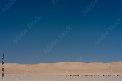 Coastal Sand Dunes under a large blue sky near Walvis Bay, Namibia
