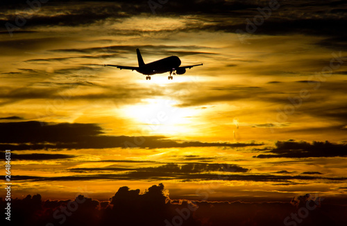AIrplane landing at sunset