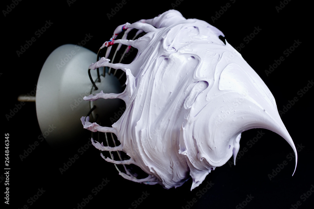 Perfect whipped stable meringue on mixer whisk isolated on black background - obrazy, fototapety, plakaty 