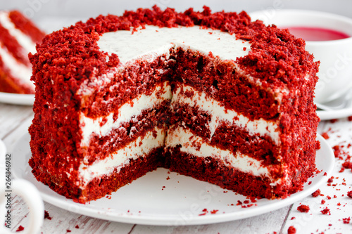 Red velvet cake, classic three layered cake from red butter sponge cakes with cream cheese frosting, American cuisine photo