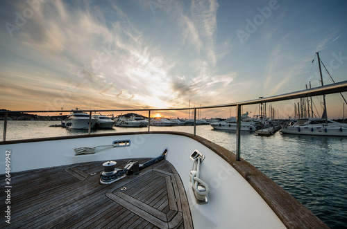 Wide angle shot of front of the yacht in marina in sunset