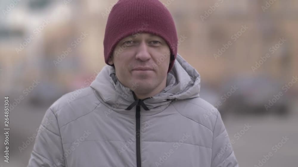 portrait of a man against the background of moving cars in winter portrait of a man against the background of moving cars in winter