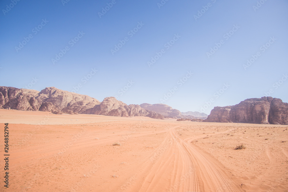 A beautiful day in the Jordanian desert of Wadi Rum. wide dessert with an amazing mountains and sand dunes , amazing scenery that you should see ! 