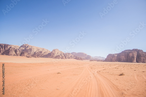 Fototapeta Naklejka Na Ścianę i Meble -  A beautiful day in the Jordanian desert of Wadi Rum. wide dessert with an amazing mountains and sand dunes , amazing scenery that you should see ! 