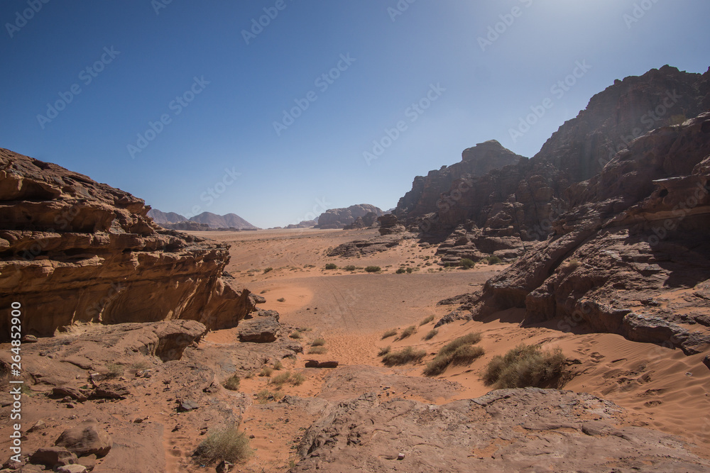 Fototapeta premium A beautiful day in the Jordanian desert of Wadi Rum. wide dessert with an amazing mountains and sand dunes , amazing scenery that you should see ! 