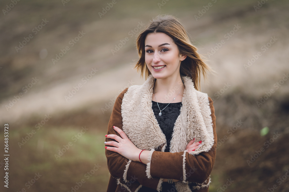 beautiful young women in the park or field or track. girl in brown coat near the road. emotional soulful portrait. lady with red manicure short white haircut smiling. long road behind background beautiful young women in the park or field or track. girl in brown coat near the road. emotional soulful portrait. lady with red manicure short white haircut smiling. long road behind background