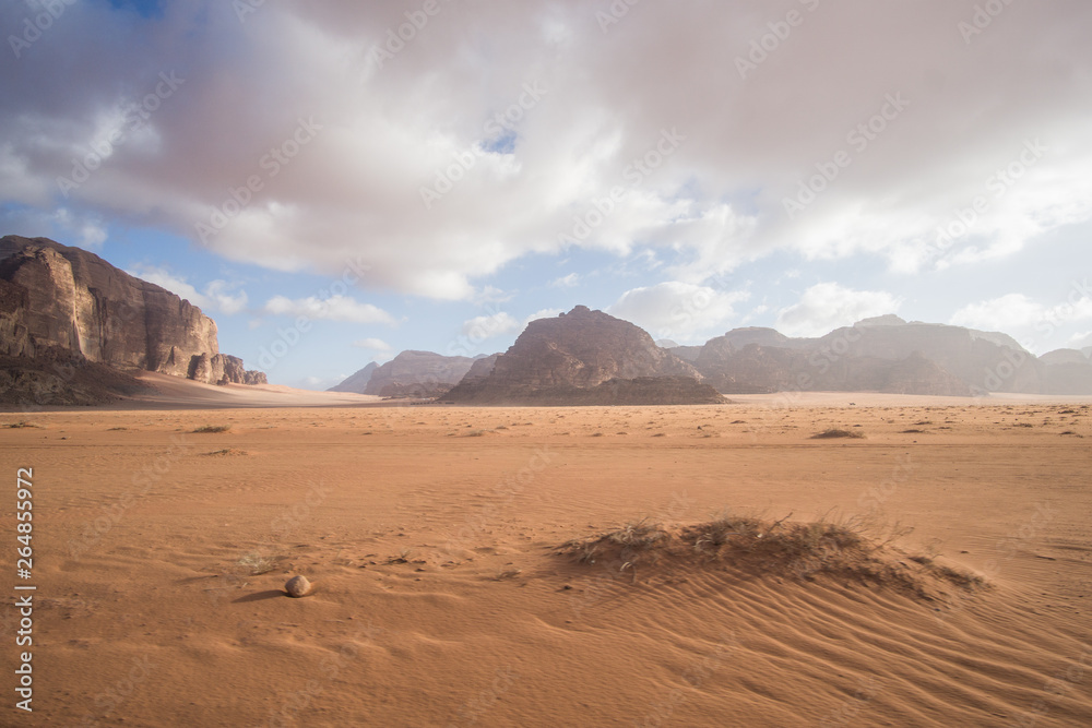 A beautiful day in the Jordanian desert of Wadi Rum. wide dessert with an amazing mountains and sand dunes , amazing scenery that you should see ! 