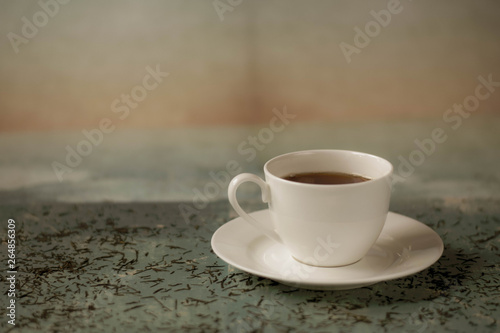 A cup of hot tea with different colours background.