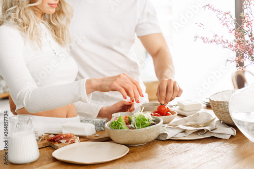 Young couple preparing a healthy and nutritious vegetable salad. Healthy food. Diet. Dietary salad.