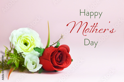 Happy Mothers Day card. Bunch of artificial flowers on pink background