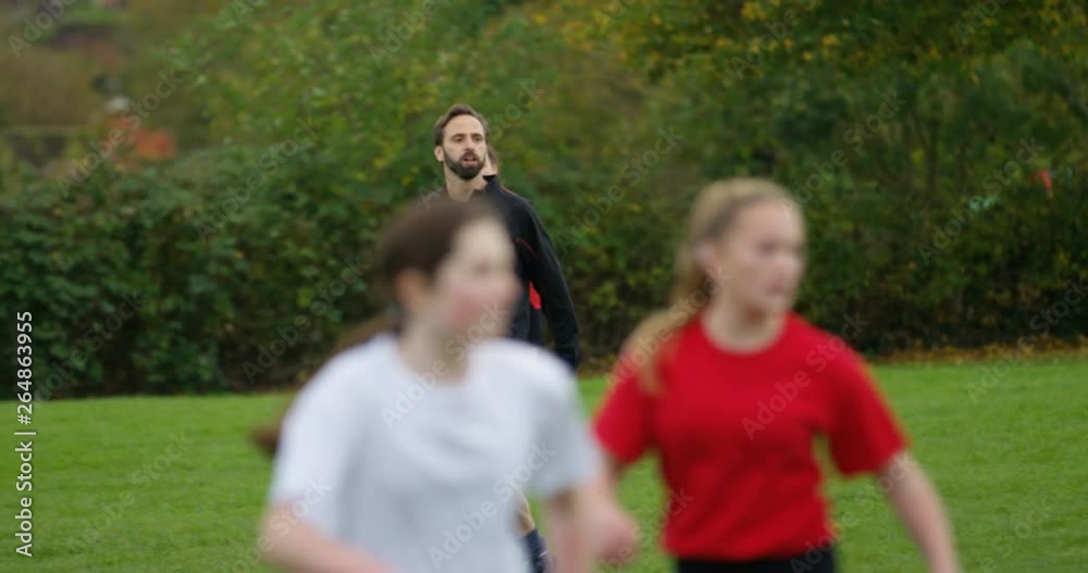 4K Soccer coach shouting instructions to female players at a football match. Slow motion. 4K Soccer coach shouting instructions to female players at a football match. Slow motion.