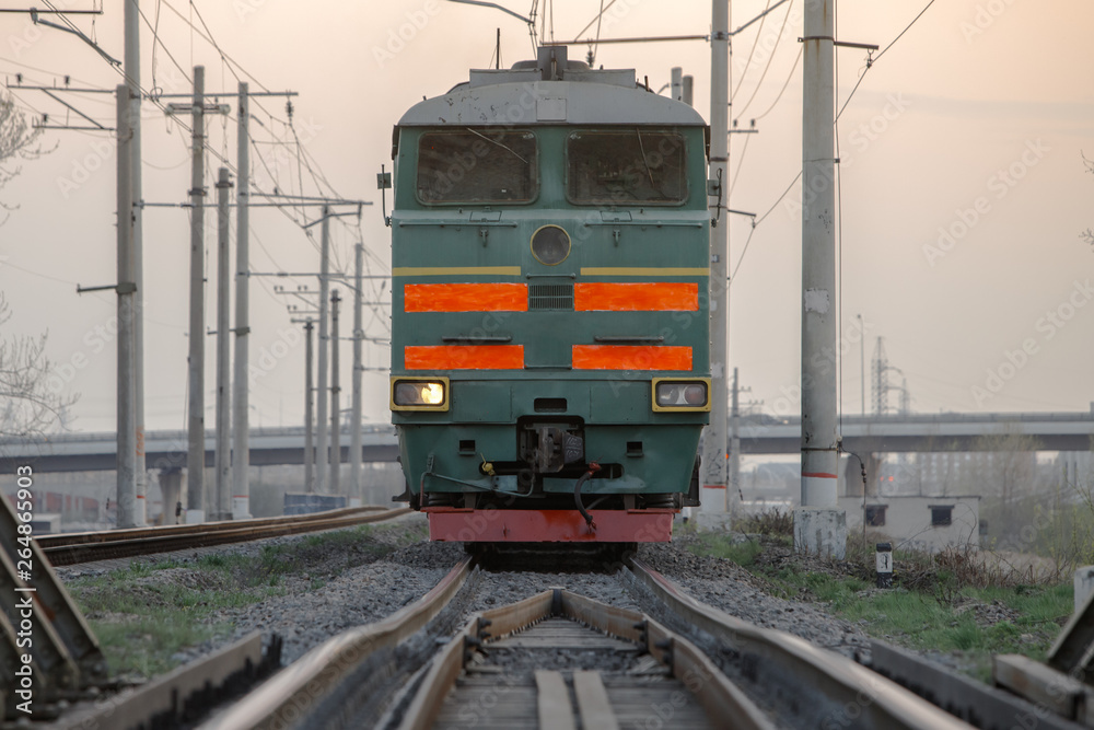 Obraz premium Front view of soviet powerful diesel locomotive on the railroad early morning. 